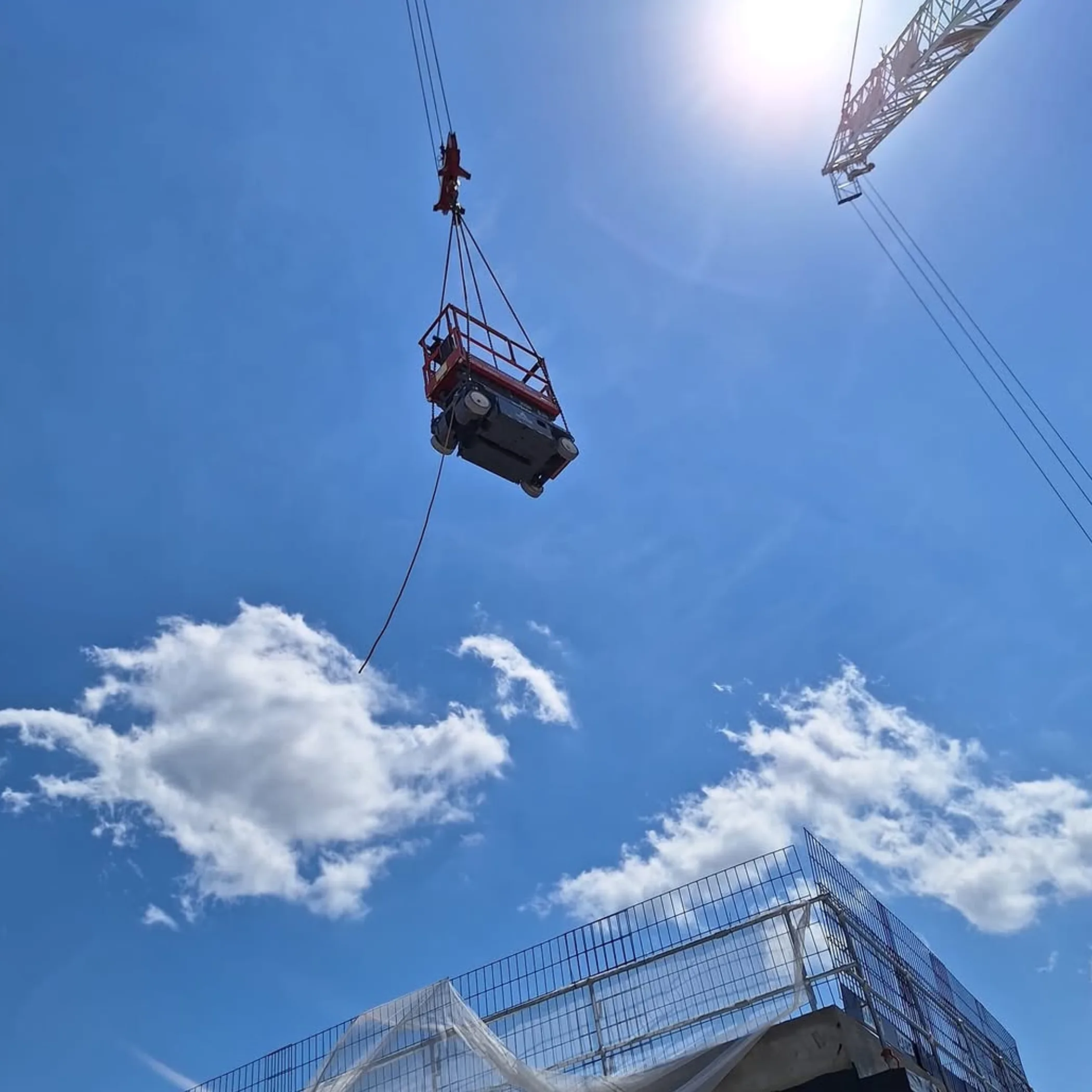 powered access equipment beside high-rise structure